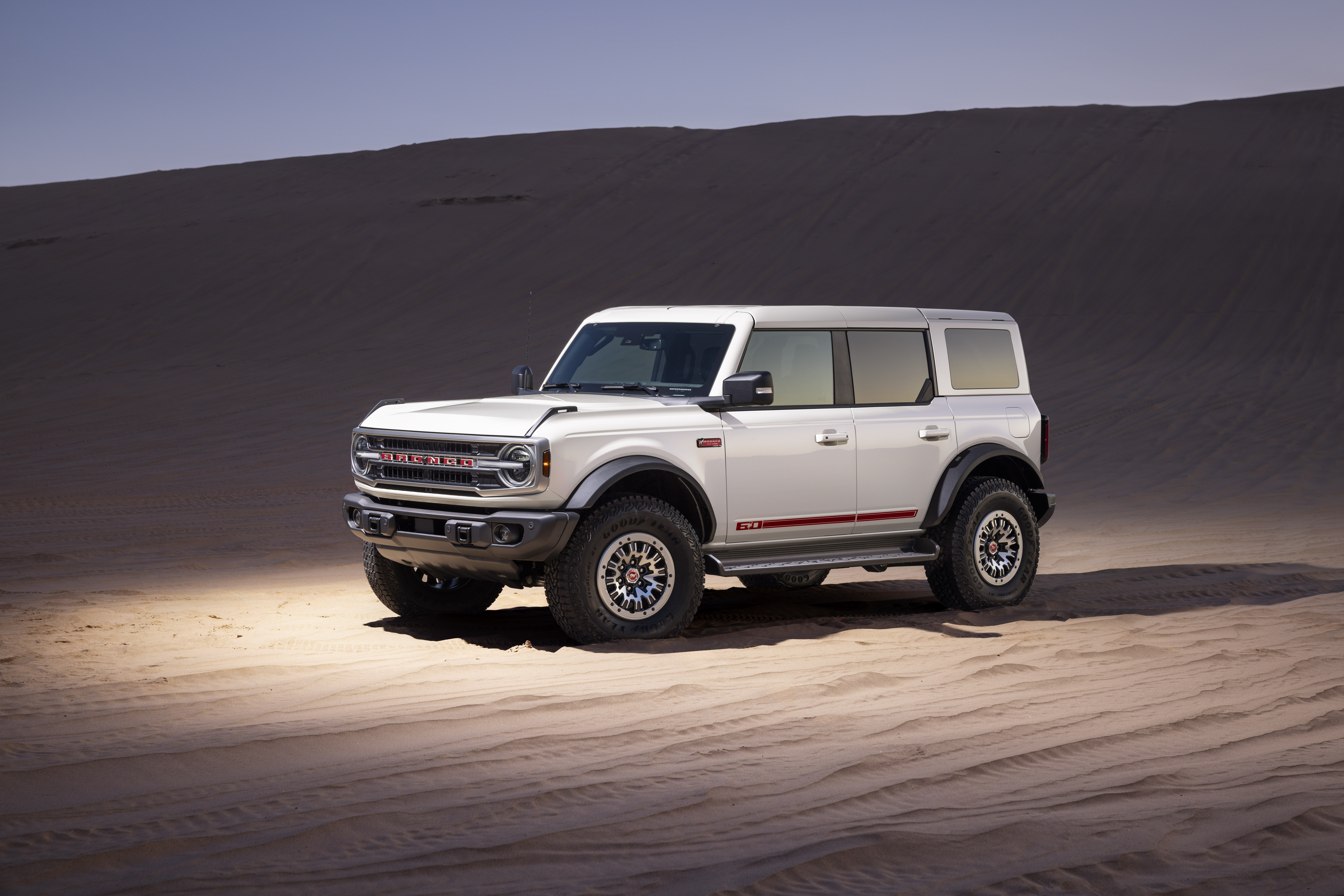 Preproduction model shown. The Bronco 60th Anniversary Package blends bolder colors and accents in the cabin, timeless visuals on the exterior, and the same uncompromising off-road capability owners expect.
